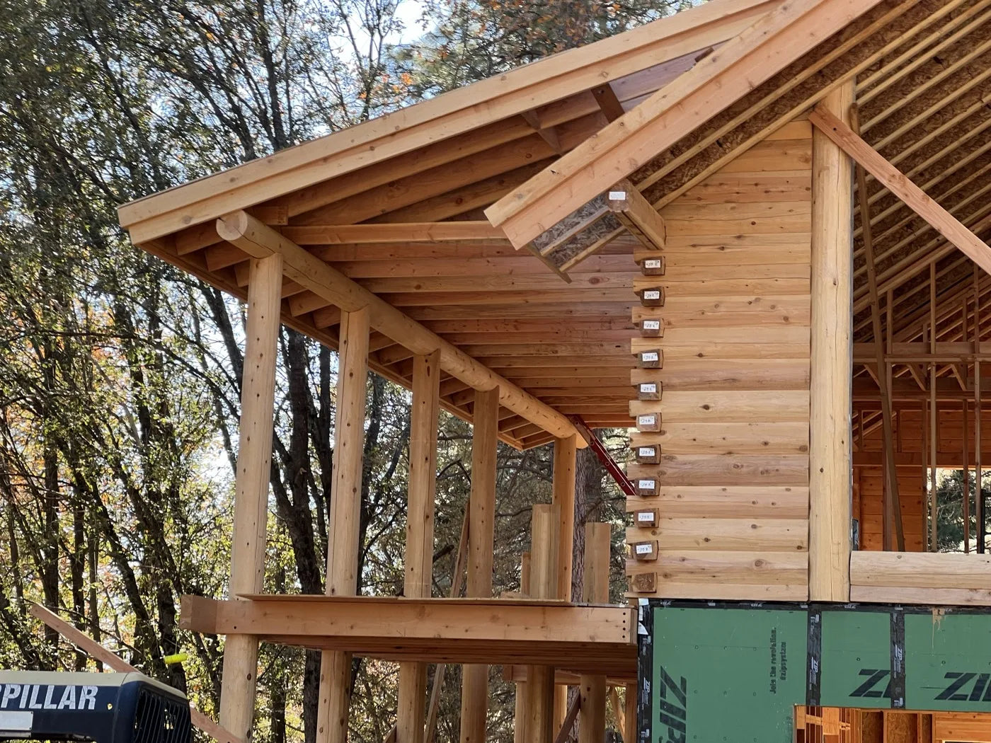 Covered porch with round log posts and log home framing detail