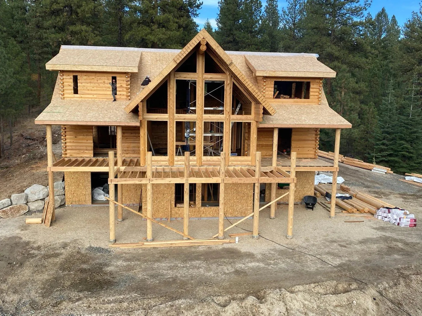 Cedar log home under a covered breezeway connecting two building sections