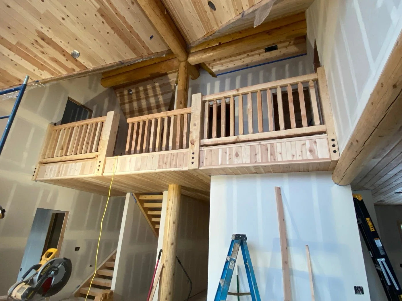 Loft hallway with log railings overlooking the great room below