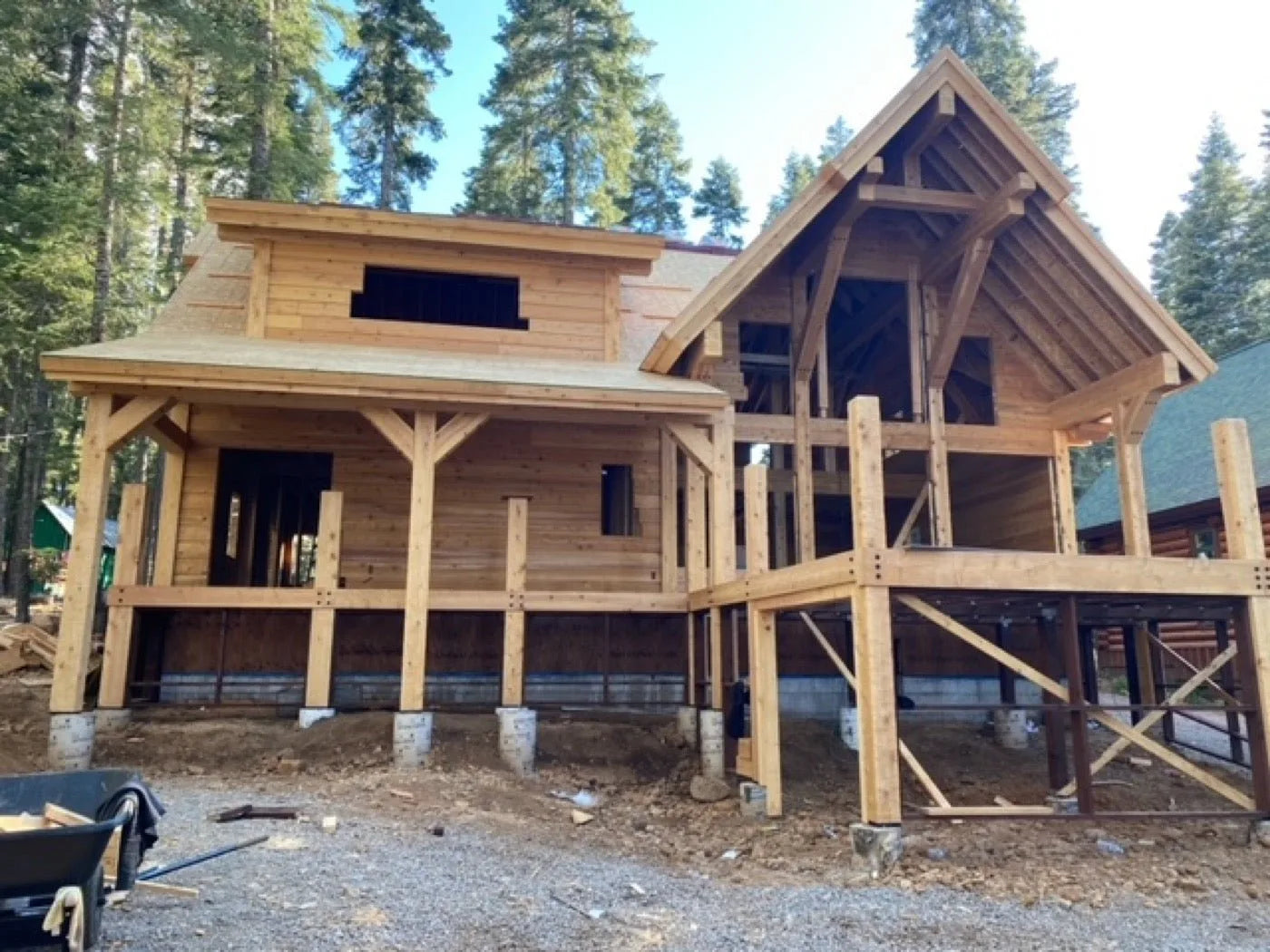 Log home front elevation with covered porch and large picture windows