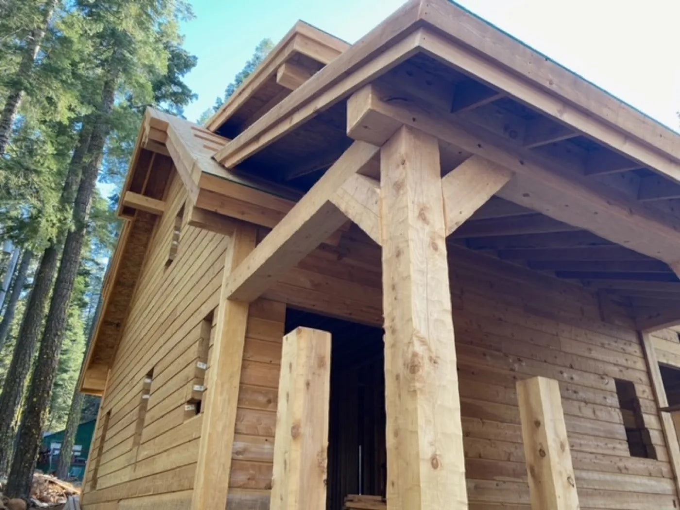 Close-up of a peeled cedar porch post and roof overhang detail