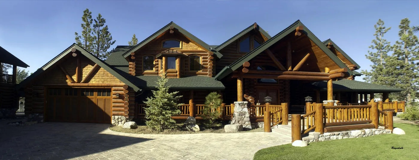 Panoramic view of a finished log home with stained cedar siding and stone accents