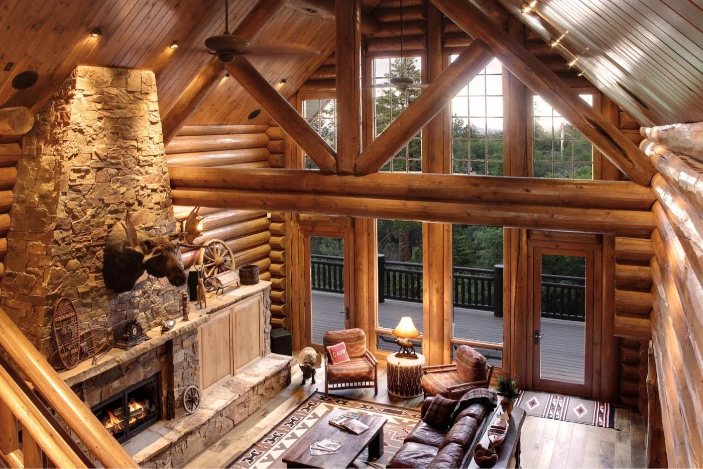 Log home great room loft with log stair railing and skylight