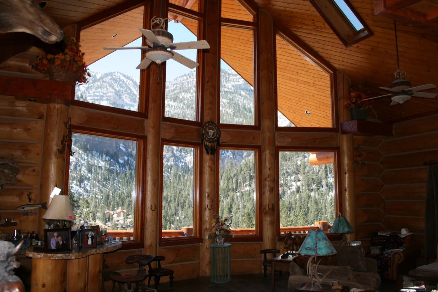 Great room with floor-to-ceiling windows framing a snow-capped mountain view